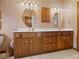 Bathroom featuring double sink vanity with wooden cabinets and tile flooring at 2810 Winterway Dr, Shelbyville, IN 46176