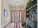Inviting foyer with tiled floor, decorative shelving, and elegant lighting fixture at 2810 Winterway Dr, Shelbyville, IN 46176