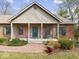 Inviting front porch with a brick facade, green shutters, and a cozy bench offering curb appeal at 2810 Winterway Dr, Shelbyville, IN 46176