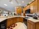 Open kitchen with oak cabinets, stainless steel fridge, and breakfast bar at 2810 Winterway Dr, Shelbyville, IN 46176