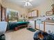 This laundry room offers ample space, featuring storage cabinets, a folding table, and a view to the outdoors at 2810 Winterway Dr, Shelbyville, IN 46176