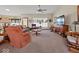 Cozy living room with plush carpet, ceiling fan, and lots of natural light at 2810 Winterway Dr, Shelbyville, IN 46176