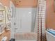This shower has a built-in seat and a handheld shower head, as well as a curtain for privacy at 2810 Winterway Dr, Shelbyville, IN 46176