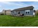 Exterior shot of the home with a large yard and patio at 2890 Trillium Way, Columbus, IN 47201