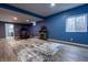 Finished basement featuring blue walls, wood-look floors, a fireplace, and exercise equipment at 2890 Trillium Way, Columbus, IN 47201