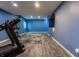 Finished basement featuring a treadmill, stone fireplace, and wood-look tile floors at 2890 Trillium Way, Columbus, IN 47201