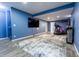 Finished basement featuring blue walls, wood-look floors, a fireplace, and exercise equipment at 2890 Trillium Way, Columbus, IN 47201