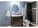 Cozy bathroom with a dark vanity, round mirror, and tile shower at 2890 Trillium Way, Columbus, IN 47201