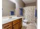Bathroom featuring a wooden vanity, a large mirror, and a shower with a patterned curtain at 2890 Trillium Way, Columbus, IN 47201