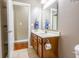 Bathroom featuring a wooden vanity, large mirror, and tiled flooring at 2890 Trillium Way, Columbus, IN 47201
