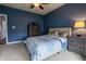 Blue bedroom with a ceiling fan, carpet flooring, and a queen-sized bed at 2890 Trillium Way, Columbus, IN 47201