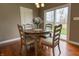 Cozy dining area featuring a round wooden table with four chairs and sliding glass doors to the outside at 2890 Trillium Way, Columbus, IN 47201