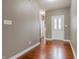 Welcoming entryway featuring gleaming hardwood floors and a stylish front door with decorative glass at 2890 Trillium Way, Columbus, IN 47201