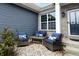 Inviting front porch seating area with comfortable blue chairs, perfect for relaxing outdoors at 2890 Trillium Way, Columbus, IN 47201