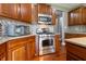 Gleaming kitchen with stainless steel oven, microwave and backsplash at 2890 Trillium Way, Columbus, IN 47201