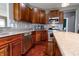 Well-lit kitchen featuring stainless steel appliances, granite countertops, and wooden cabinets at 2890 Trillium Way, Columbus, IN 47201