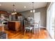 Open kitchen with stainless steel appliances, a center island, and adjacent dining area with sliding glass doors at 2890 Trillium Way, Columbus, IN 47201