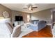 Spacious living room boasts hard wood floors, ceiling fan, and comfortable seating at 2890 Trillium Way, Columbus, IN 47201