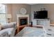 Cozy living room with fireplace, mantle clock, hardwood floors, and natural light at 2890 Trillium Way, Columbus, IN 47201