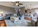 Open floorplan living room featuring hardwood floors, cozy seating, and adjacent breakfast bar at 2890 Trillium Way, Columbus, IN 47201