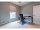 Office featuring carpet flooring, a window view, a desk, and a gray office chair at 2890 Trillium Way, Columbus, IN 47201