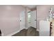 A pink room with two doorways showcases a wooden floor at 3015 S Rybolt Ave, Indianapolis, IN 46241