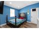 This charming bedroom features bright blue walls and wood flooring at 3015 S Rybolt Ave, Indianapolis, IN 46241
