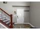 Well-lit foyer featuring stylish wood flooring, a staircase, and a white front door at 3015 S Rybolt Ave, Indianapolis, IN 46241