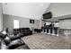 Spacious living room open to the kitchen, featuring modern floors and a high, vaulted ceiling at 3015 S Rybolt Ave, Indianapolis, IN 46241