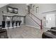 Open-concept living space with a staircase, bar seating, and stylish flooring at 3015 S Rybolt Ave, Indianapolis, IN 46241