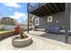 Outdoor patio featuring a fire pit, grill, and comfortable seating beneath a balcony with string lights at 3015 S Rybolt Ave, Indianapolis, IN 46241