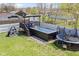 Backyard featuring an above ground pool with sundeck alongside trampoline and climbing wall at 3015 S Rybolt Ave, Indianapolis, IN 46241