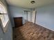 Comfortable bedroom with blue walls, wood-look floors, and ample closet space at 314 S Taft Ave, Indianapolis, IN 46241