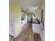 Bright kitchen featuring white cabinets, appliances, and wood-look flooring at 314 S Taft Ave, Indianapolis, IN 46241