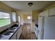 Cozy kitchen with white appliances and cabinets, brightened by natural light from the adjacent room at 314 S Taft Ave, Indianapolis, IN 46241