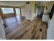 Inviting living room and kitchen featuring stylish flooring and a view of the front yard at 314 S Taft Ave, Indianapolis, IN 46241