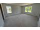 A bright, unfinished bedroom with two windows allowing for plenty of natural light at 3297 Godby Dr, Sheridan, IN 46069