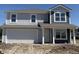 Charming two-story home featuring gray and navy siding, complemented by white trim and an attached two-car garage at 3297 Godby Dr, Sheridan, IN 46069