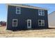 Back exterior of the home features navy siding with plenty of windows for lots of natural light at 3297 Godby Dr, Sheridan, IN 46069