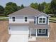 Charming two-story home with a two-car garage, inviting front porch, and manicured lawn at 3297 Godby Dr, Sheridan, IN 46069