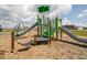 Community playground featuring slides, swings, climbing structures, and soft landing surface for enjoyment at 3297 Godby Dr, Sheridan, IN 46069