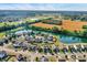 An aerial view shows a suburban neighborhood with homes surrounding a pond and golf course at 3529 Miesha Dr, Indianapolis, IN 46217