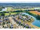 An aerial view shows a suburban neighborhood, golf course, and a lake at 3529 Miesha Dr, Indianapolis, IN 46217