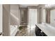 Bright bathroom features a soaking tub, vanity with dual sinks, and slate flooring at 3529 Miesha Dr, Indianapolis, IN 46217