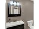 Updated half bath with vanity, modern lighting, and a new mirror at 3529 Miesha Dr, Indianapolis, IN 46217