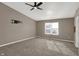 Spacious bedroom features plush carpeting, a modern ceiling fan, and a TV mount at 3529 Miesha Dr, Indianapolis, IN 46217