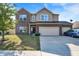 Traditional two-story home with brick and siding, attached three-car garage and manicured lawn at 3529 Miesha Dr, Indianapolis, IN 46217