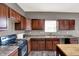 Well-lit kitchen featuring wood cabinets, laminate countertops and black appliances at 3529 Miesha Dr, Indianapolis, IN 46217