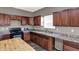 Modern kitchen with an island, wood cabinets, and stainless appliances for a cooking space designed for functionality at 3529 Miesha Dr, Indianapolis, IN 46217