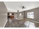 Open-concept living area with hardwood floors, a ceiling fan, and plenty of natural light flowing into the kitchen at 3529 Miesha Dr, Indianapolis, IN 46217